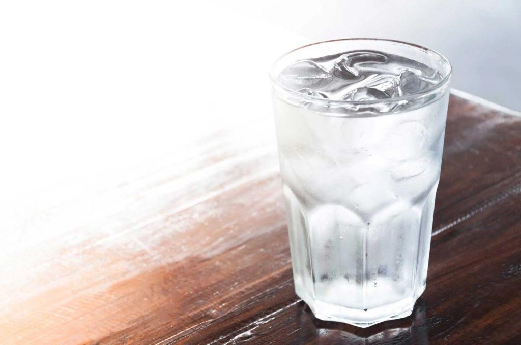 A glass with full of water and ice cube